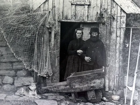 Icelandic fisherman and wife posing in front of their sod house. 2nd half of the 19th Century