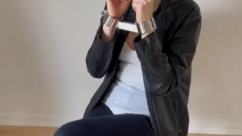Enjoying my shiny rigid shackles (GIF)