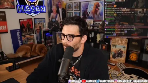 Hasan reaching for something and seemingly shocking his dog to keep her in camera view