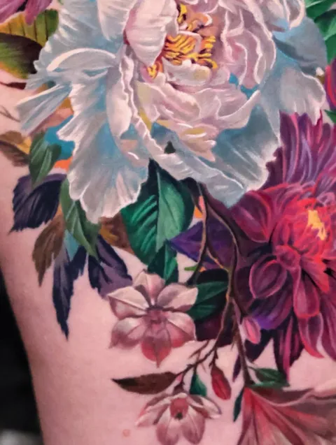Mixed floral arrangement thigh piece by @angel.antonio.tattoos of Black Atlas Studios, Chicago