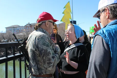 A protestor and armed counter-protestor argue at a protest in Idaho Falls, Idaho on April 5. (OC)