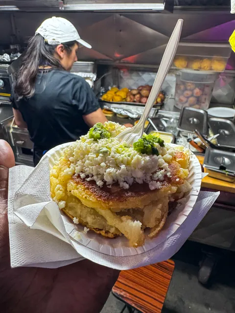 [I ate] Arepas filled with cheese. Topped with more cheese and green sauce!