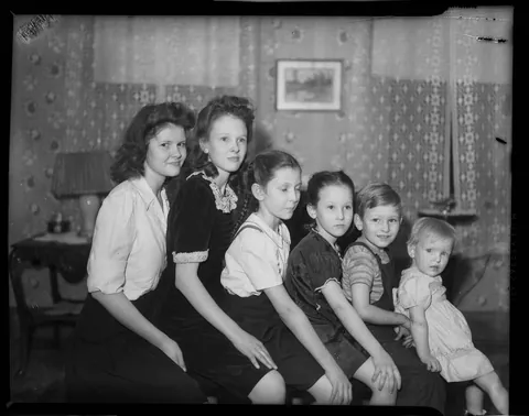 Group of siblings posing for their photo sit by age, circa 1944.
