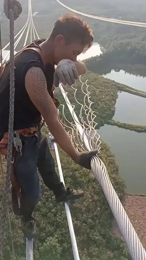 Electricity wires being manually wrapped for protection.