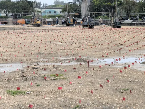 Bunch of red flags at a construction site.