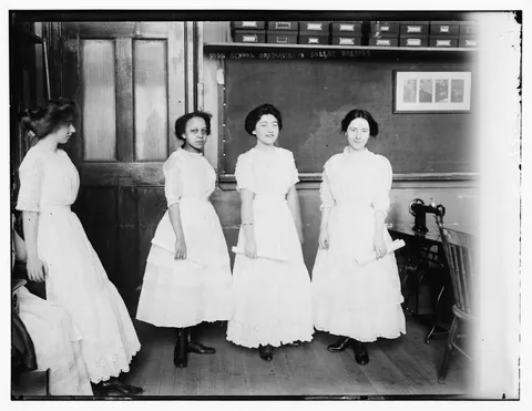 Ladies with their 1 dollar dress. Women used to learn in some classes how to make a dress in a 1 dollar budget in the early 1900s. Glass negative