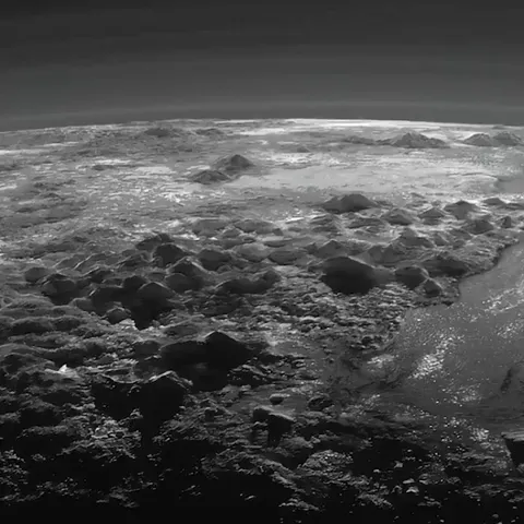 Pluto’s ice mountains, frozen plains and layers of atmospheric haze backlit by a distant sun, as seen by the New Horizons spacecraft.