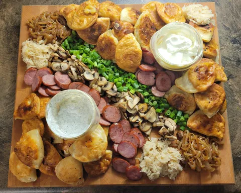 [OC] Pierogi Board with Caramelized Onion, Green Onion, Grilled Mushrooms, Kielbasa, Saurkraut