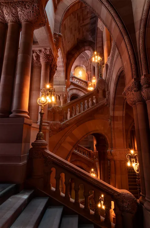 An ornate red sandstone staircase.