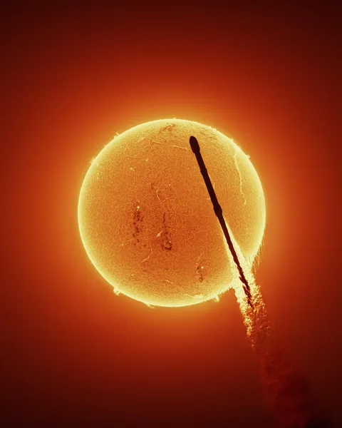 I set up a solar telescope in a wildlife refuge 8 miles from a launch pad to capture this: A Falcon 9 rocket transiting our sun. Apparently this is the first image of it's kind, revealing the details of the solar chromosphere behind an ascending rocket! More info in the comments. [OC]