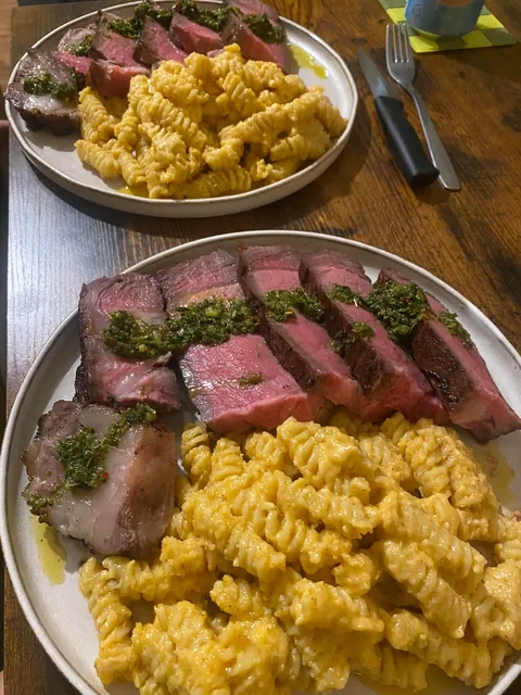 [Homemade] Tomahawk steak with mac &amp; cheese and chimichurri sauce for my girlfriend's birthday dinner.