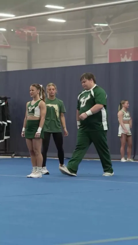 Big dude cheerleading on campus