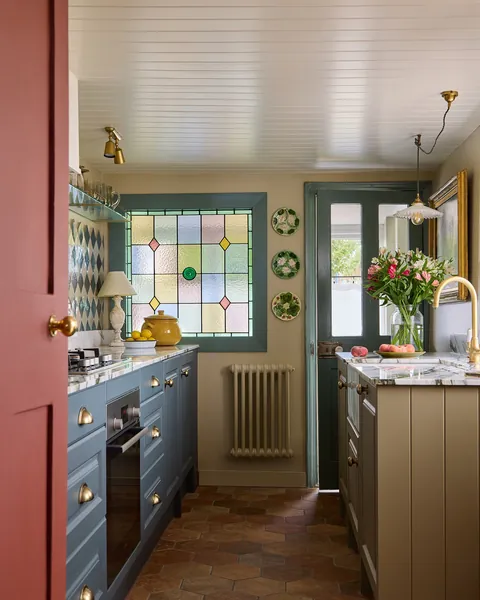 Compact kitchen with a stained glass window in an 18th-century cottage, seaside town of Deal, Kent, England [1619x2024]