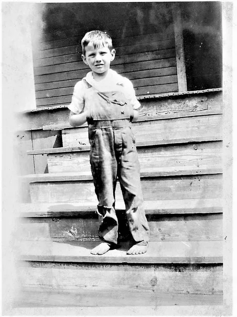 Love this picture of my dad. Even into his 80s, he would sometimes wear overalls and he would always tuck his hands into them like this to keep them warm. Circa 1930