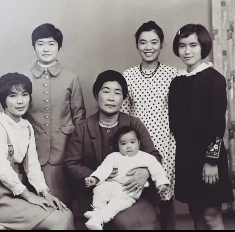 My mom in the middle with my grandmother and her sisters. My great grandmother is holding my mom. Okinawa 1968