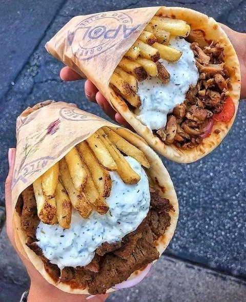 A couple of mouthwatering gyros with fries