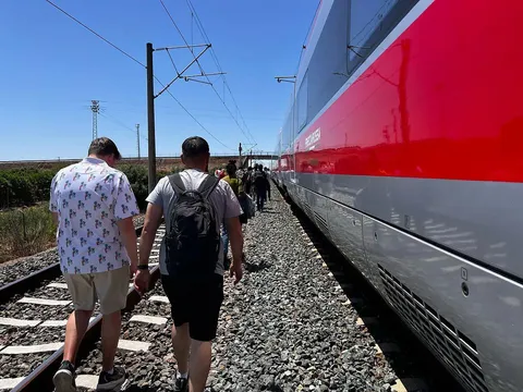 Passengers evacuating high-speed trains after the power outage in Spain