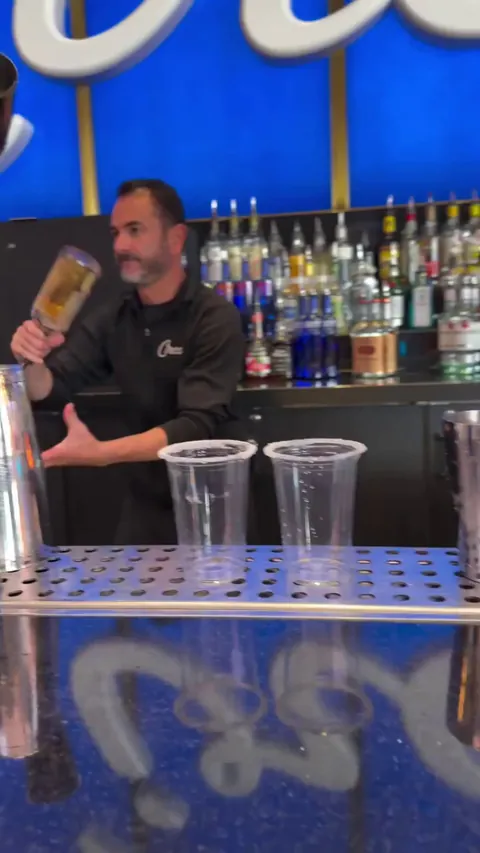 A bartender showing mad skills while pouring a drink