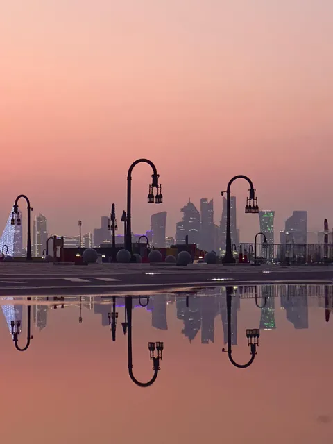 ITAP of a street and the skyline reflecting on a puddle