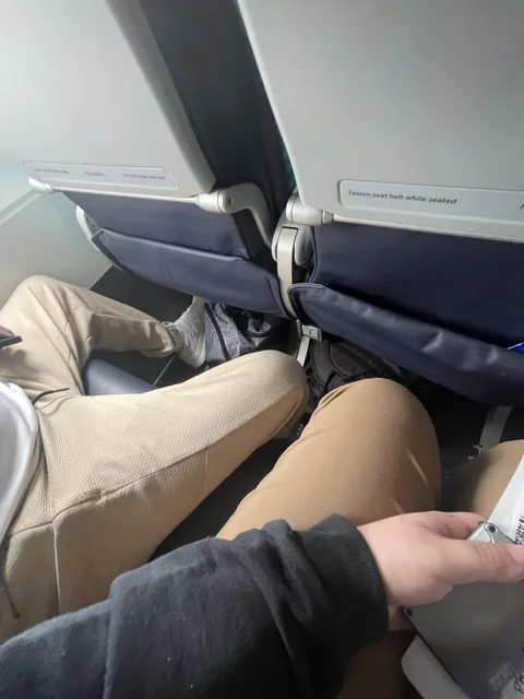 Dude sat like this for the ENTIRE flight. No matter how much I tried to push back against his legs.