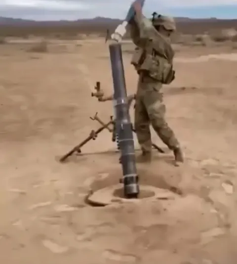 Slow-mo shot of a U.S. soldier firing a mortar