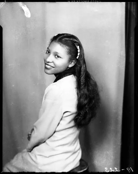 Young lady poses looking over her left shoulder for her photo, 1946.