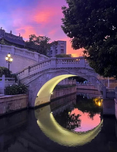 The lighting under this bridge that makes it look like a Crescent-Moon in the water.