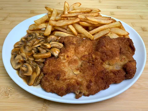 Schnitzel with fries and mushrooms
