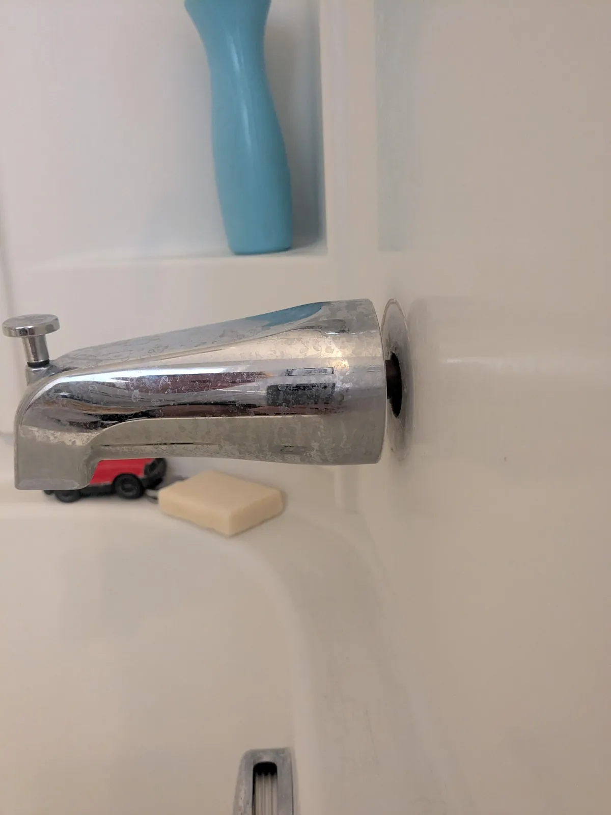 I told my wife I'd fix this in six months. It is now six months later. How do I reattach this to the wall? Initially there was this hardened putty but it broke down. The screw on the underside of the spout doesn't help.