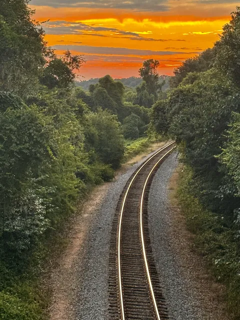 This fiery sunset over the curving train tracks