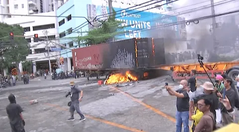 Protesters set fire to a container van at Ayala Bridge