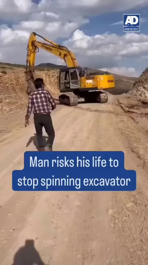Man stopping a spinning excavator