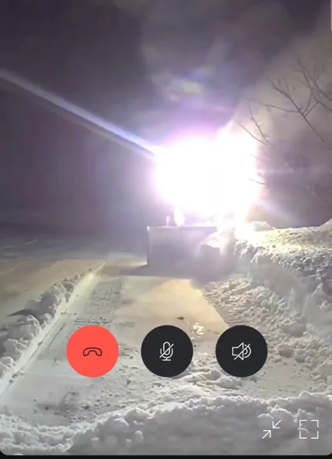 My neighbor clearing our driveway after 14" snowfall while we're on vacation...