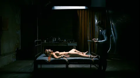 Strapped down tight to the bed with no escape.
