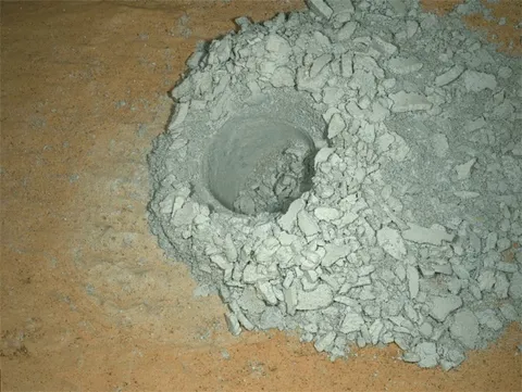 Curiosity's latest drill hole in a rock nicknamed "Edinburgh". The hole is about 0.6 inches (1.6 cm) in diameter and 2 inches (5 cm) deep. This photo was taken by night on 22 March 2020, the surface being lightened by LEDs.