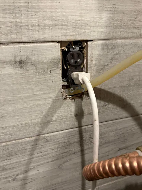 Water line running underneath the outlet and through the electrical box?? lol