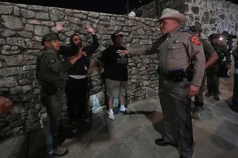 Protesters against immigration enforcement are detained by Texas troopers near the Alamo,San Antonio
