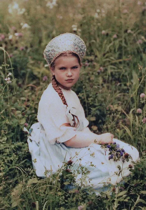 Little girl from Yalta, Crimea, poses for a photo in the grass, 1910-11. This is not colorized, is an autochrome.