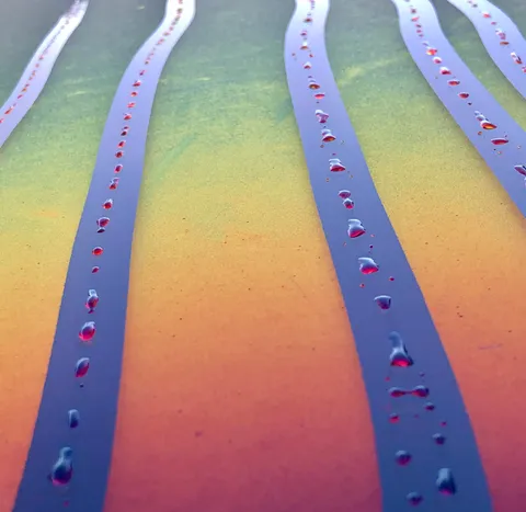 ITAP of dragging fingers over dew on roof of car
