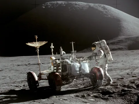 Jim Irwin with the Lunar Roving Vehicle on the Moon. Mons Hadley is in the background.  	Taken on 31 July 1971