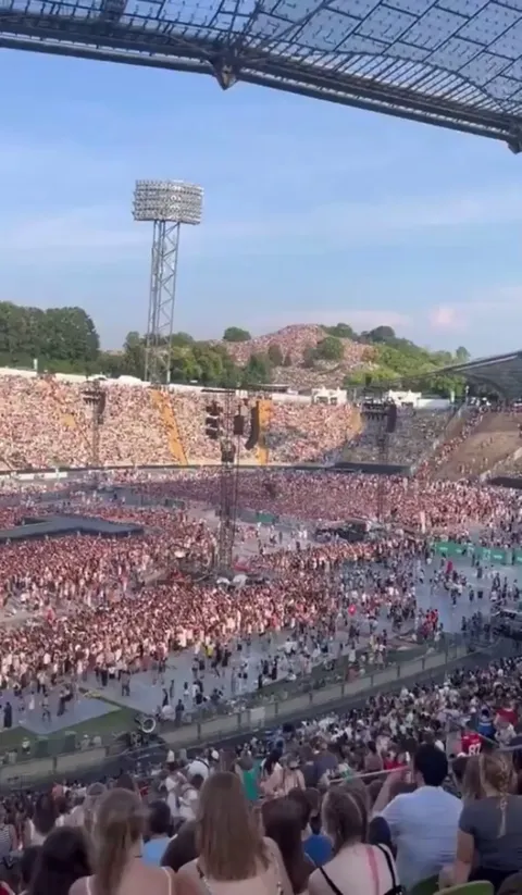 The crowd behind the sold-out stadium (74,000) for Taylor Swift's Eras Tour concert in Munich, Germany 