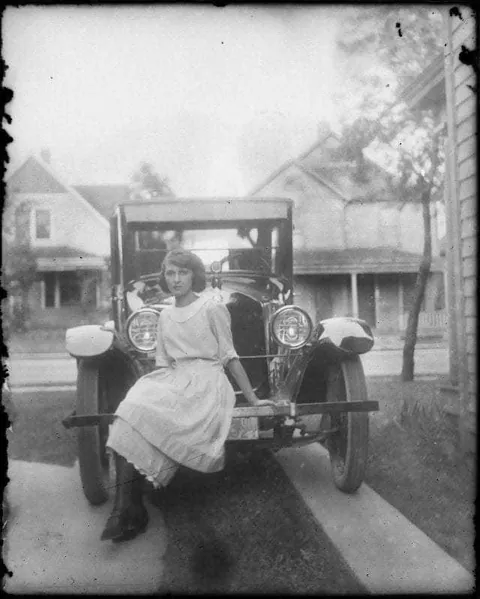 Girl posing with her car (1920)