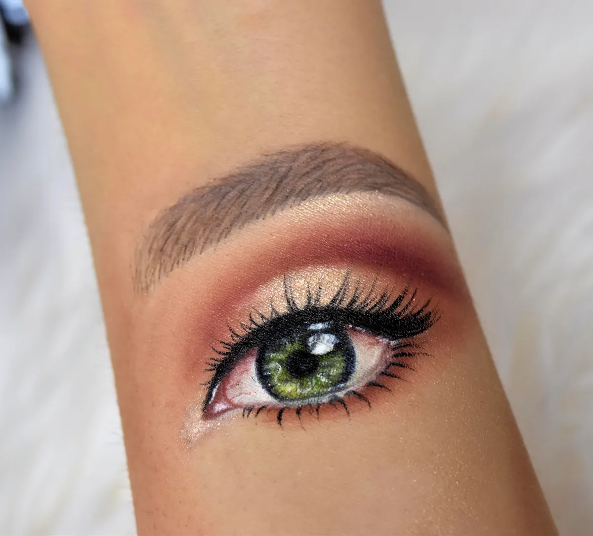 This is an eye that I painted on my hand using only makeup.