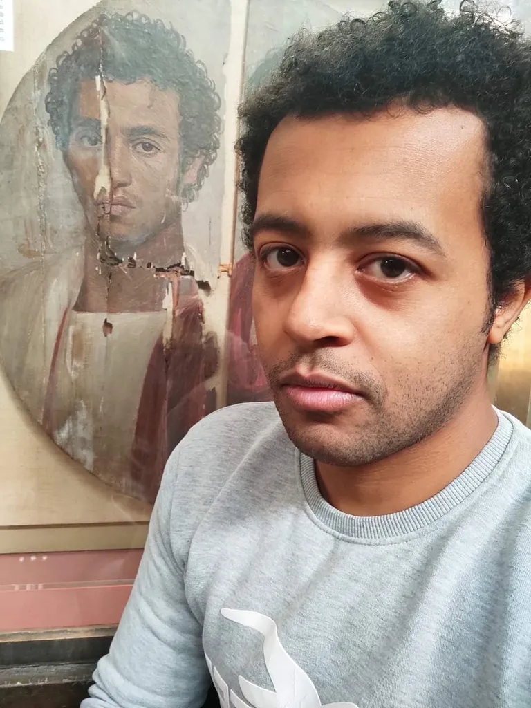 A modern Egyptian man taking a selfie with a 2000 years old portrait of an Egyptian man during the Roman era