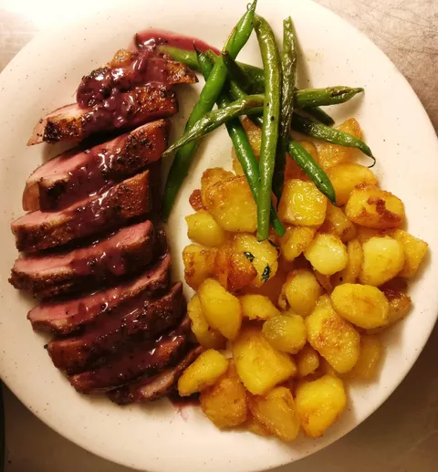 [Homemade] Duck breast with red wine &amp; blackcurrant sauce, roasted potatoes and green beans