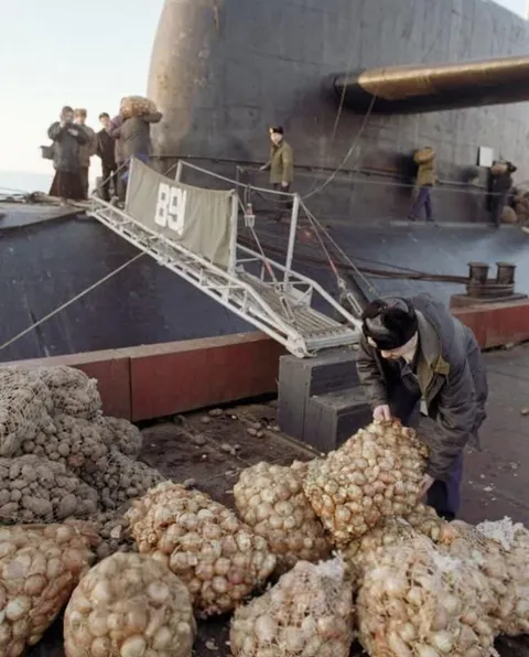 Rations being loaded onto a nuclear submarine. Gadzhievo, Murmansk Region, 1996.