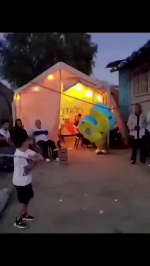 a boy playing with Piñata!