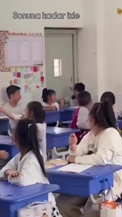 Shy kid was asked to pick a paper and if it was blank the class could go play, none knew every paper was blank. (Them hyping that shy kid made me smile throughout the video)