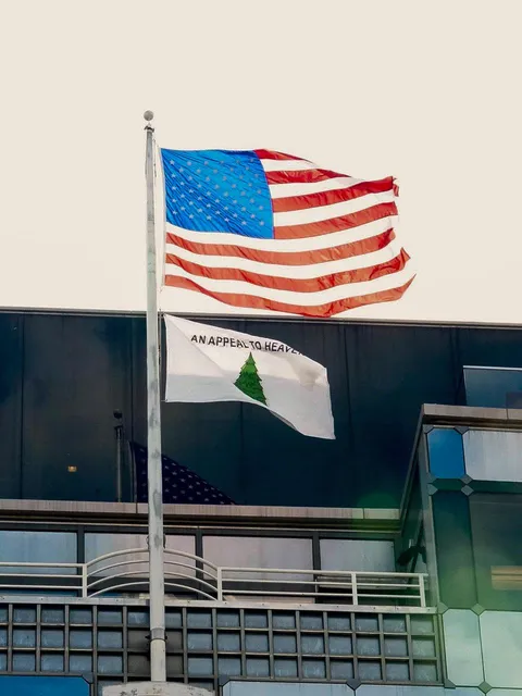 An "Appeal to heaven" flag being flown on top of the Small Business Association Government building.