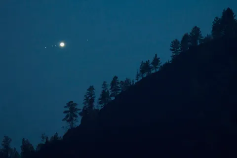 I took a picture of Jupiter (with moons) rising over the mountain forest